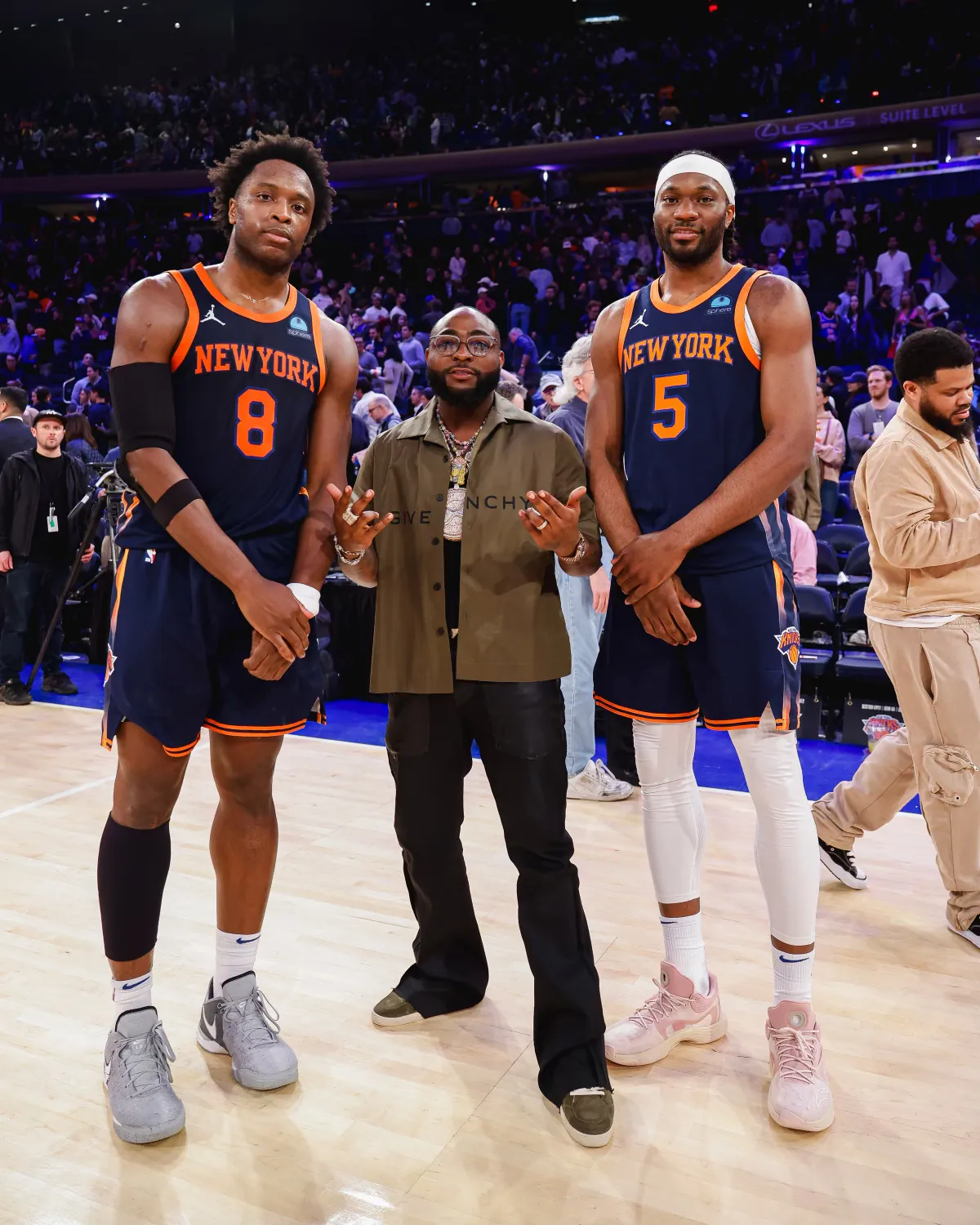 Davido on the Madison Square Garden court with Knicks players OG Anunoby and Precious Achiuwa
